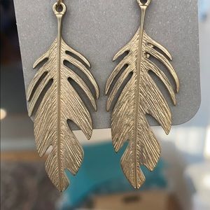 Gold colored feather earrings